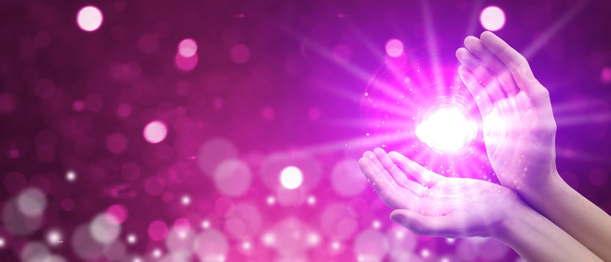Person creating bright aura energy field, spiritual enlightenment